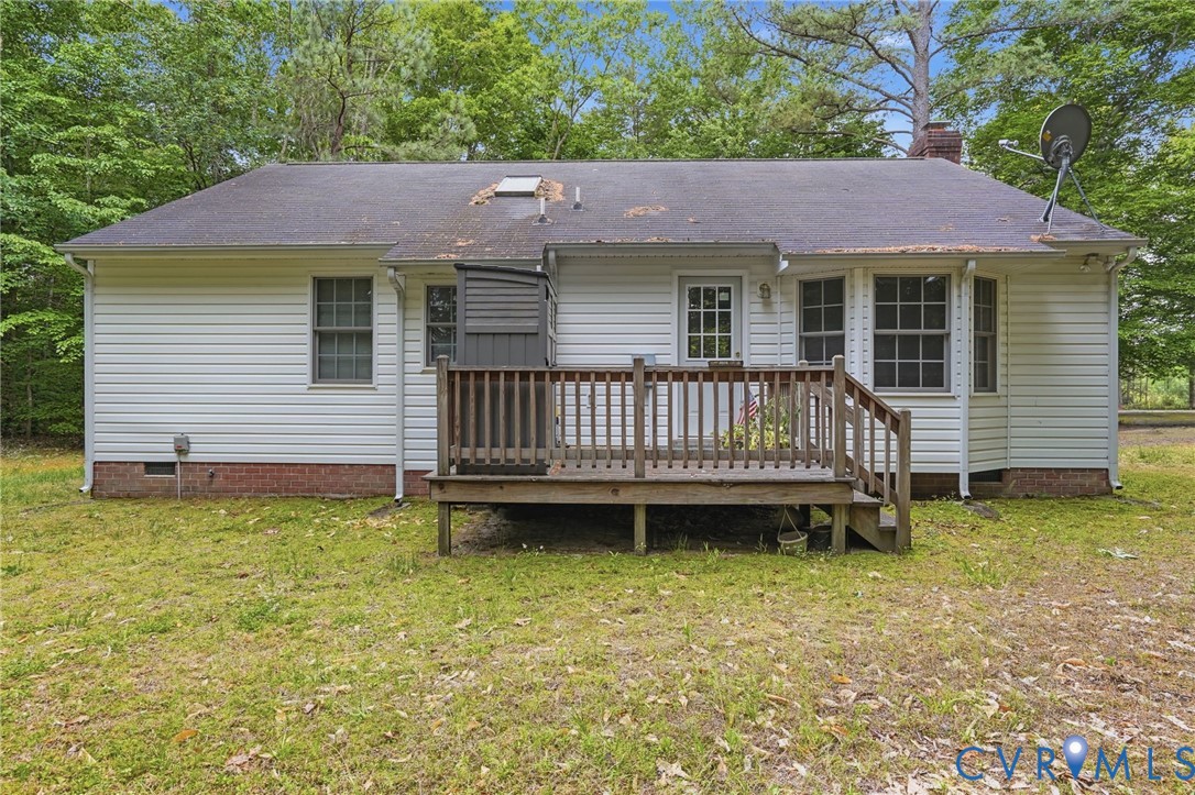 1917 Mahixon Road Manquin, VA 23106 - Photo 7 of 43 a view of a house with a wooden deck and a yard
