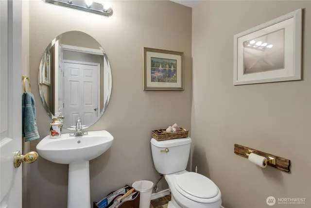 a bathroom with a toilet sink and mirror