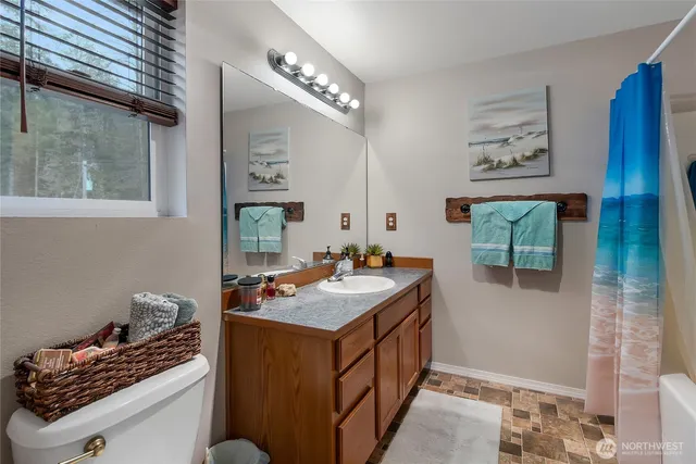 a bathroom with a sink a vanity and a mirror