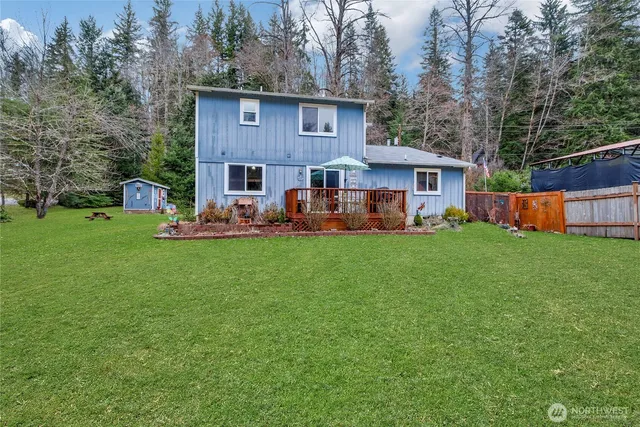 a view of a house with backyard sitting area and garden