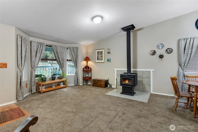 a bedroom with furniture and a large window