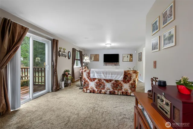 a view of a livingroom with furniture and a flat screen tv