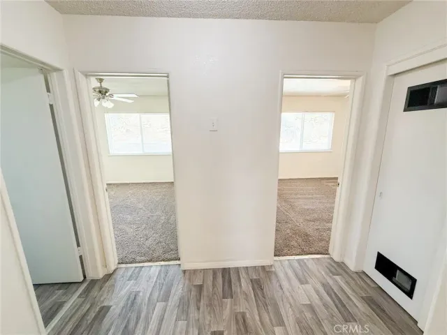 a view of a room with wooden floor and a sink