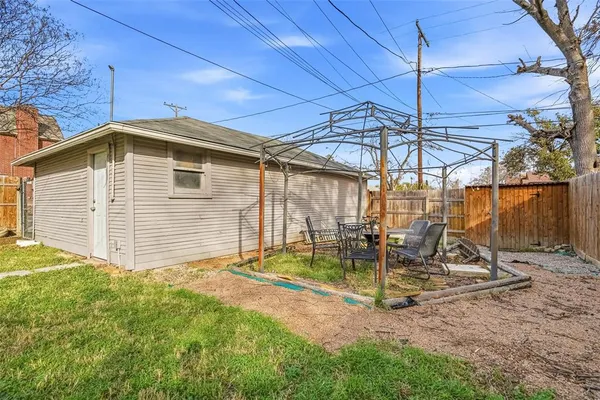 a view of a backyard with a table and chairs