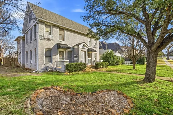 a view of a big yard with large tree
