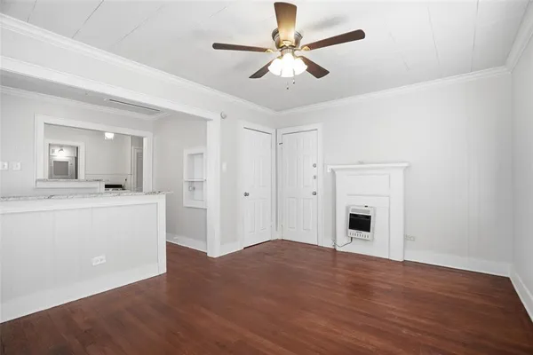 a view of a livingroom with a ceiling fan hardwood floor and a ceiling fan