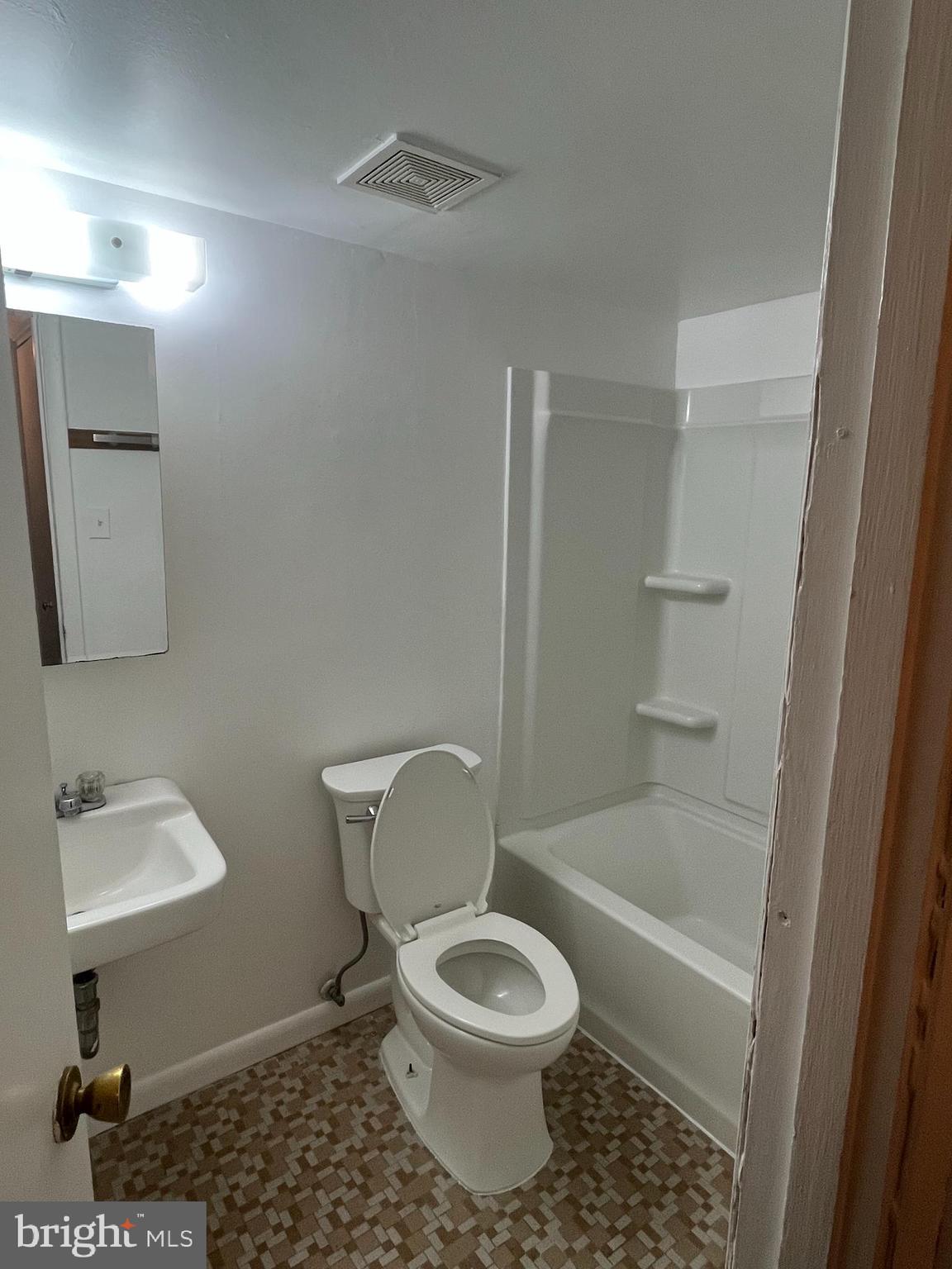 3827 St Barnabas Road, Unit 3831T Suitland, MD 20746 - Photo 11 of 11 a white toilet sitting next to a bathroom sink and vanity