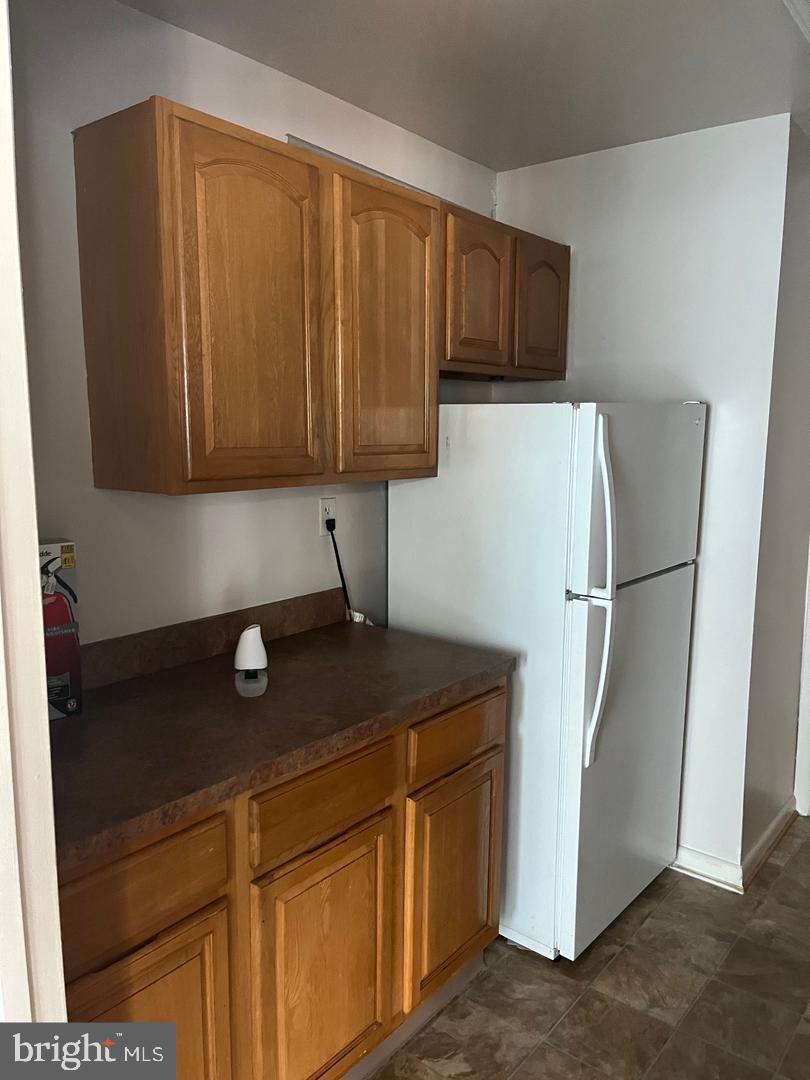 3827 St Barnabas Road, Unit 3831T Suitland, MD 20746 - Photo 8 of 11 a kitchen with a refrigerator and cabinets