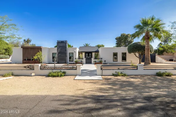a living room with furniture and large windows