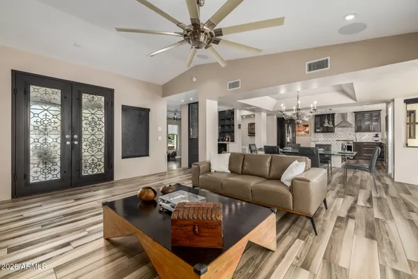 a kitchen with stainless steel appliances kitchen island granite countertop a stove a sink and a refrigerator