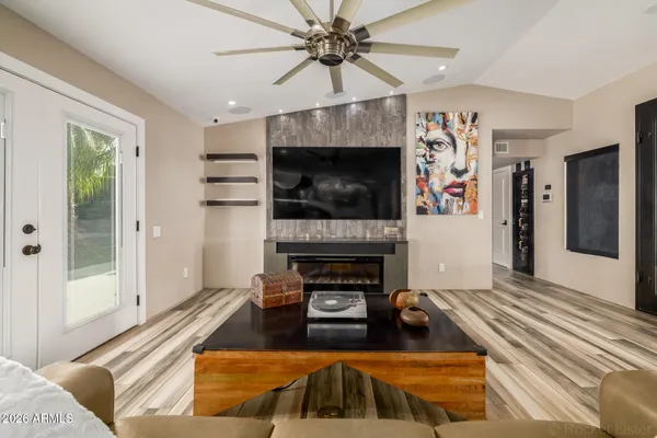 a view of a swimming pool with a lounge chair and palm trees
