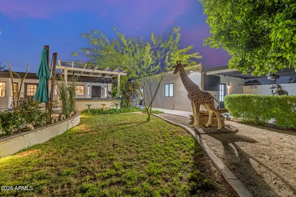 an aerial view of a city with lots of residential buildings and ocean view in back