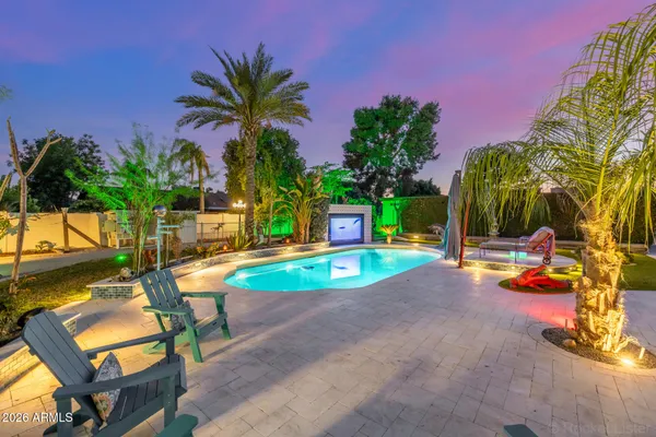 a front view of a house with yard and tree