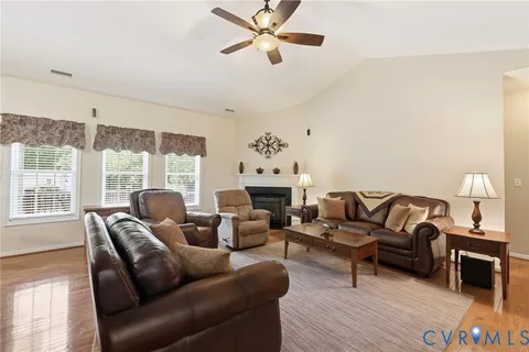 a living room with furniture a fireplace and a large window