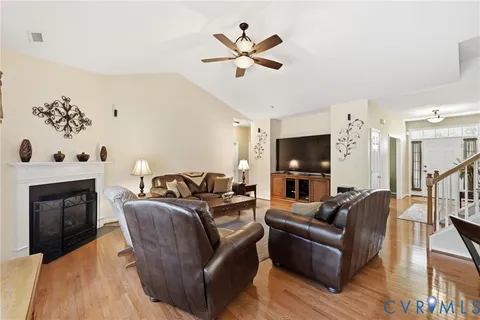 a living room with furniture fireplace and flat screen tv