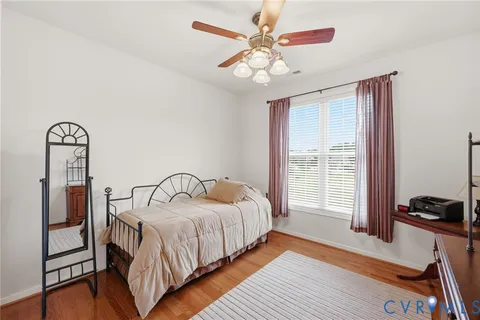 a bedroom with a bed a chandelier and a window