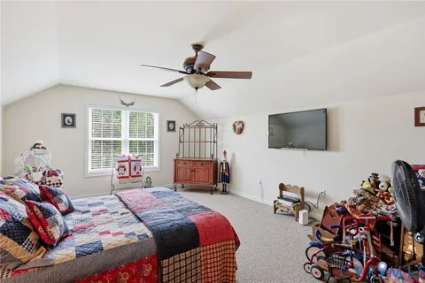 a bedroom with bed and a flat screen tv