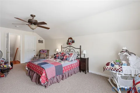 a bedroom with two beds and a chandelier
