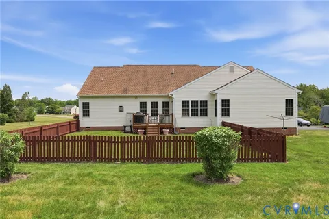 a view of a house with a yard and deck