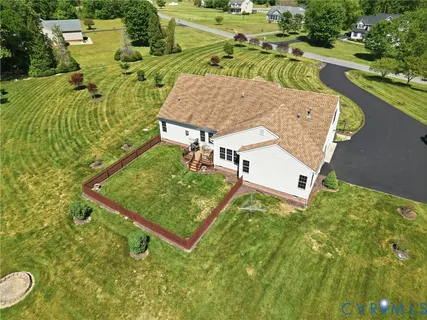 an aerial view of a house with swimming pool and outdoor seating