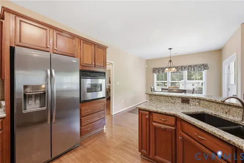 a kitchen with stainless steel appliances granite countertop a refrigerator and a sink