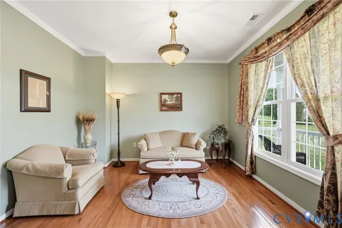 a living room with furniture a table and a large window