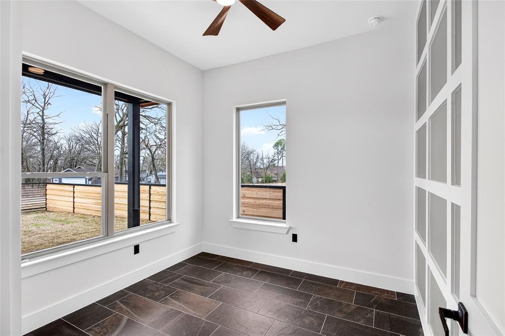 124 Aztec Drive Mabank, TX 75156 - Photo 16 of 33 Spare room featuring a ceiling fan and dark stone finish flooring