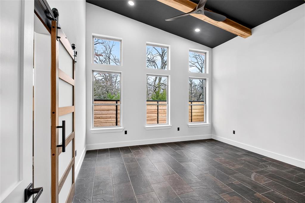 124 Aztec Drive Mabank, TX 75156 - Photo 18 of 33 Empty room with a barn door, vaulted ceiling, recessed lighting, and ceiling fan