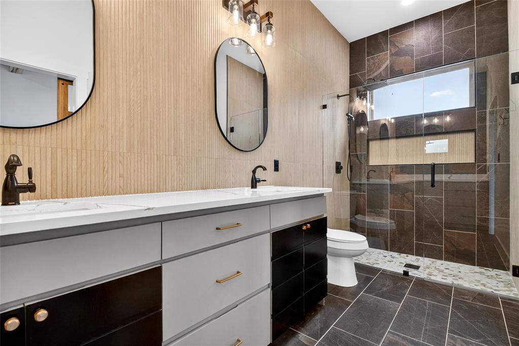 124 Aztec Drive Mabank, TX 75156 - Photo 22 of 33 Bathroom with double vanity, a shower stall, and tile walls