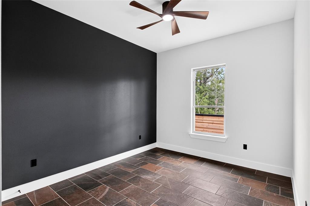 124 Aztec Drive Mabank, TX 75156 - Photo 26 of 33 Spare room featuring stone tile floors and a ceiling fan