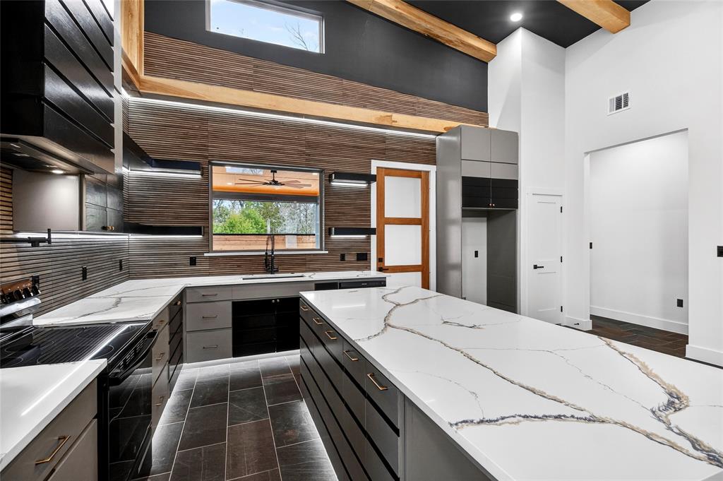 124 Aztec Drive Mabank, TX 75156 - Photo 3 of 33 Kitchen featuring black / electric stove, light stone counters, gray cabinetry, dark cabinetry, and recessed lighting