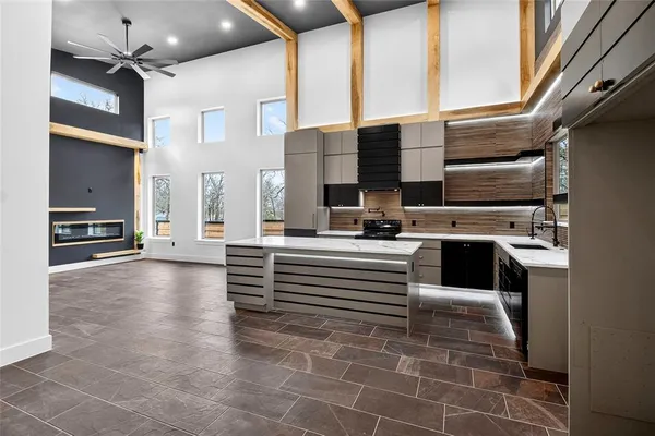 a view of living room kitchen and stainless steel appliances