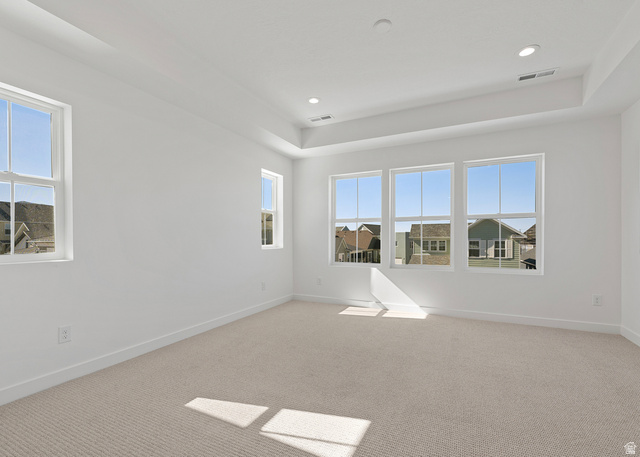 11214 South Easy Bee Road, Unit 270 South Jordan, UT 84009 - Photo 27 of 31 Neutral tone wall finishes, carpeting, and a tray ceiling with recessed lighting