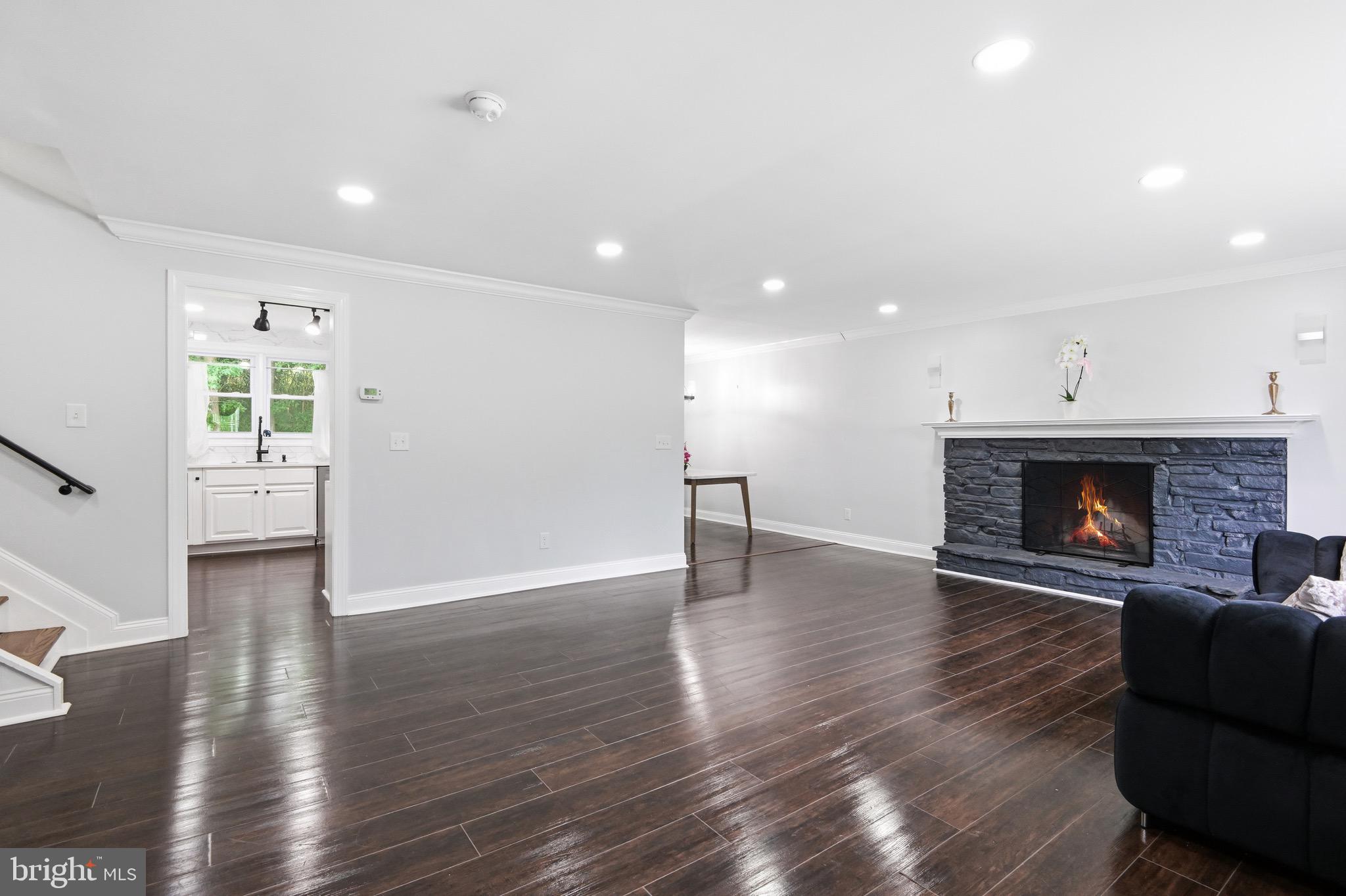 238 East Timonium Road Lutherville-Timonium, MD 21093 - Photo 18 of 40 a view of an empty room with wooden floor a fireplace and a window