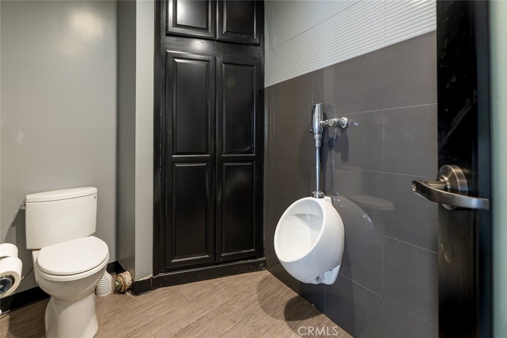 7157 Foothill Boulevard Tujunga, CA 91042 - Photo 12 of 20 a bathroom with a toilet and a mirror