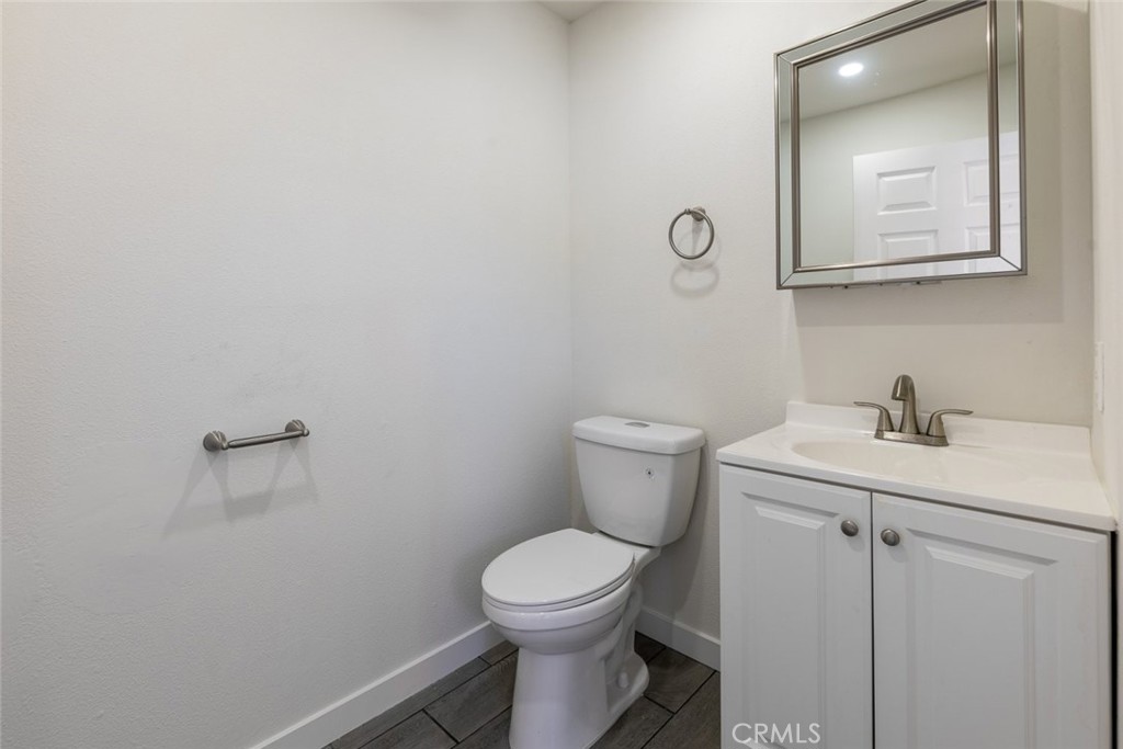 7157 Foothill Boulevard Tujunga, CA 91042 - Photo 17 of 20 a bathroom with a toilet a sink and mirror