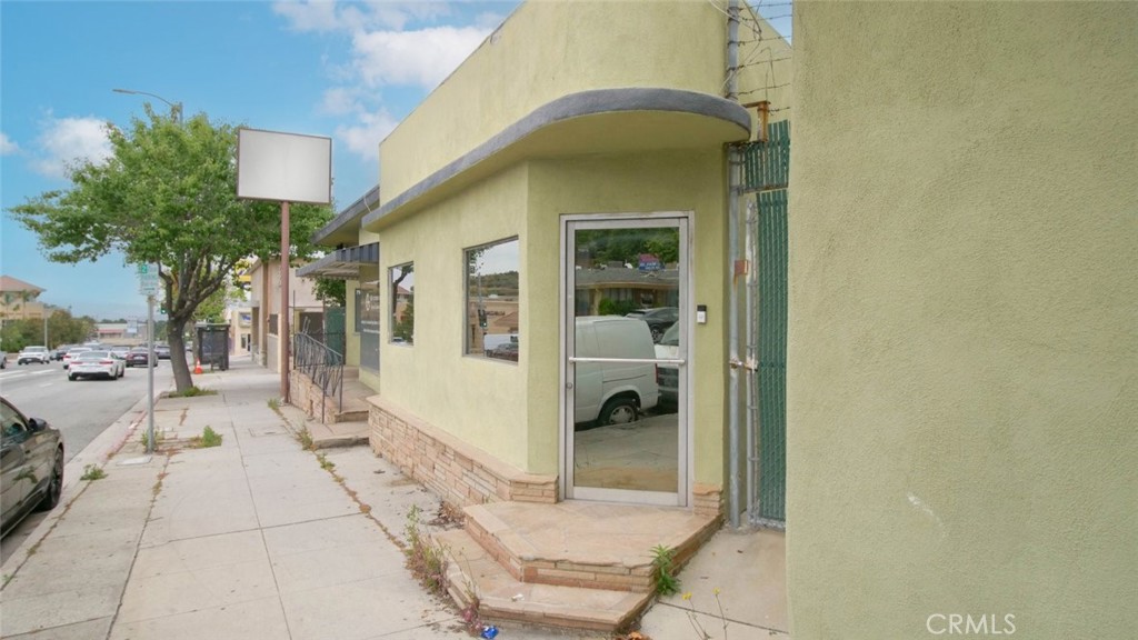7157 Foothill Boulevard Tujunga, CA 91042 - Photo 19 of 20 a view of a porch with a table and chairs and potted plants