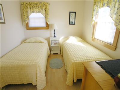 83 Uncle Rolf Road Dennis Port, MA 02639 - Photo 6 of 7 a bedroom with a bed and a painting on the wall