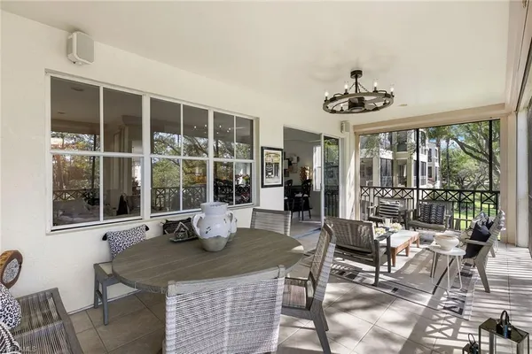 a dining room with furniture a rug and a large window