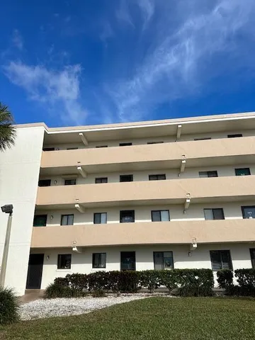 a front view of building with yard