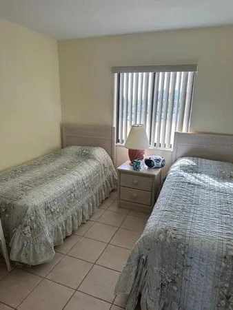 a bedroom with a bed and a mirror