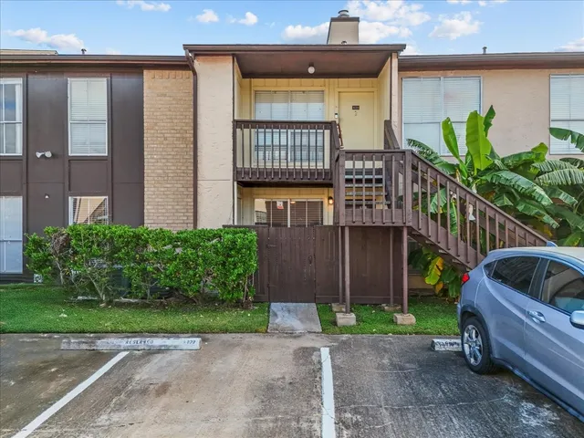 a view of a house with a small yard and a large window