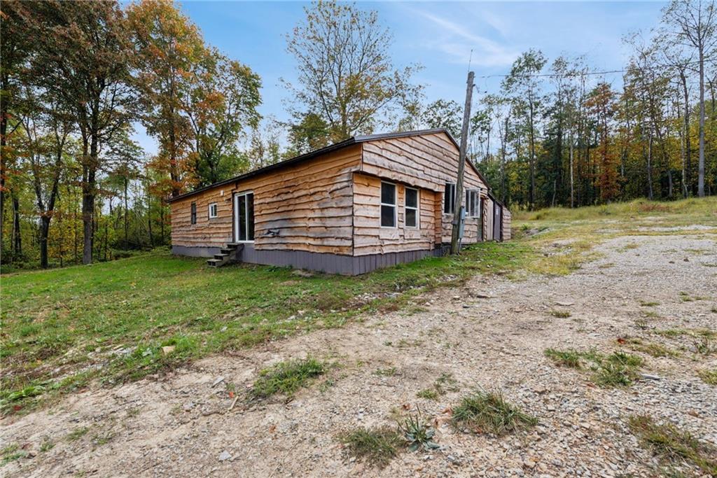 Welcome to 135 Sandy Flat Road! Charming hemlock wood siding enhances the rustic appeal of this home.