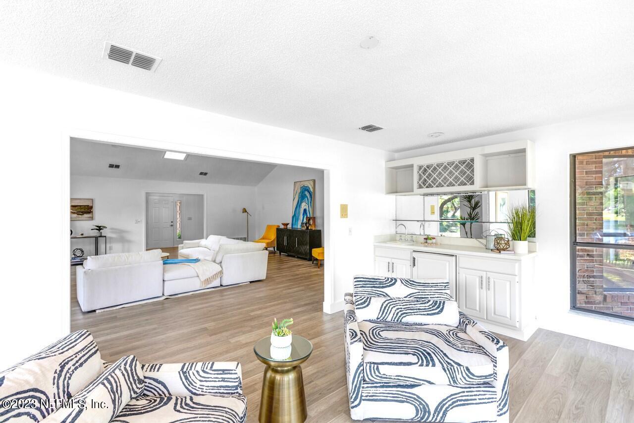 4309 Monument Road Jacksonville, FL 32225 - Photo 12 of 65 a living room with furniture and wooden floor