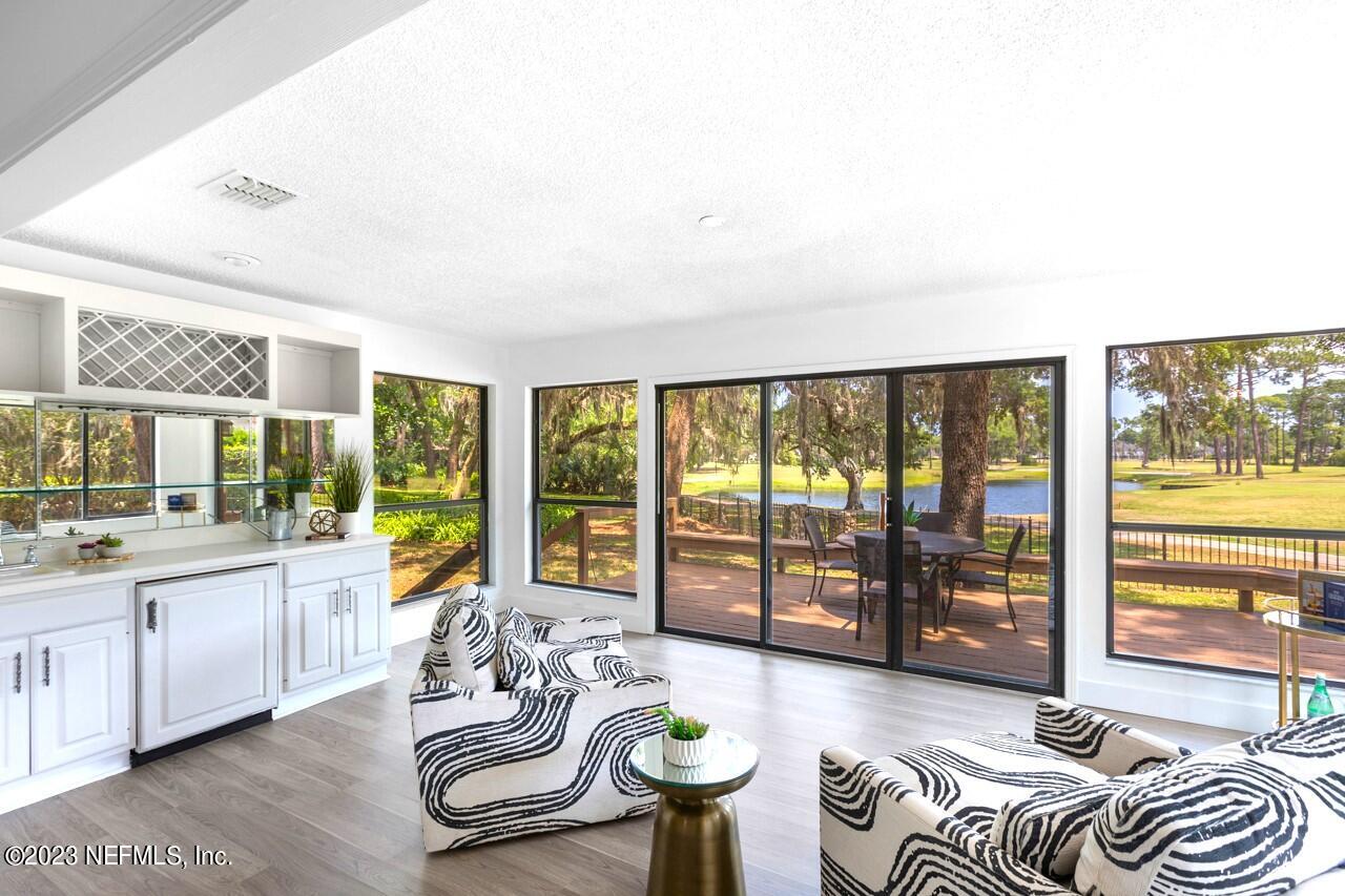 4309 Monument Road Jacksonville, FL 32225 - Photo 13 of 65 a living room with furniture and floor to ceiling windows