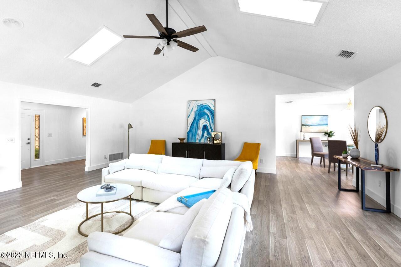 4309 Monument Road Jacksonville, FL 32225 - Photo 18 of 65 a living room with furniture and wooden floor