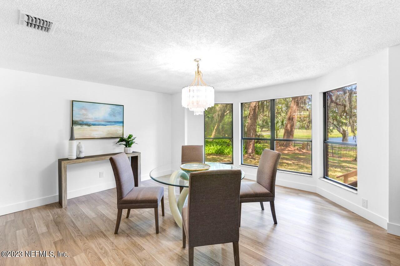 4309 Monument Road Jacksonville, FL 32225 - Photo 20 of 65 a view of a dining room with furniture window and wooden floor