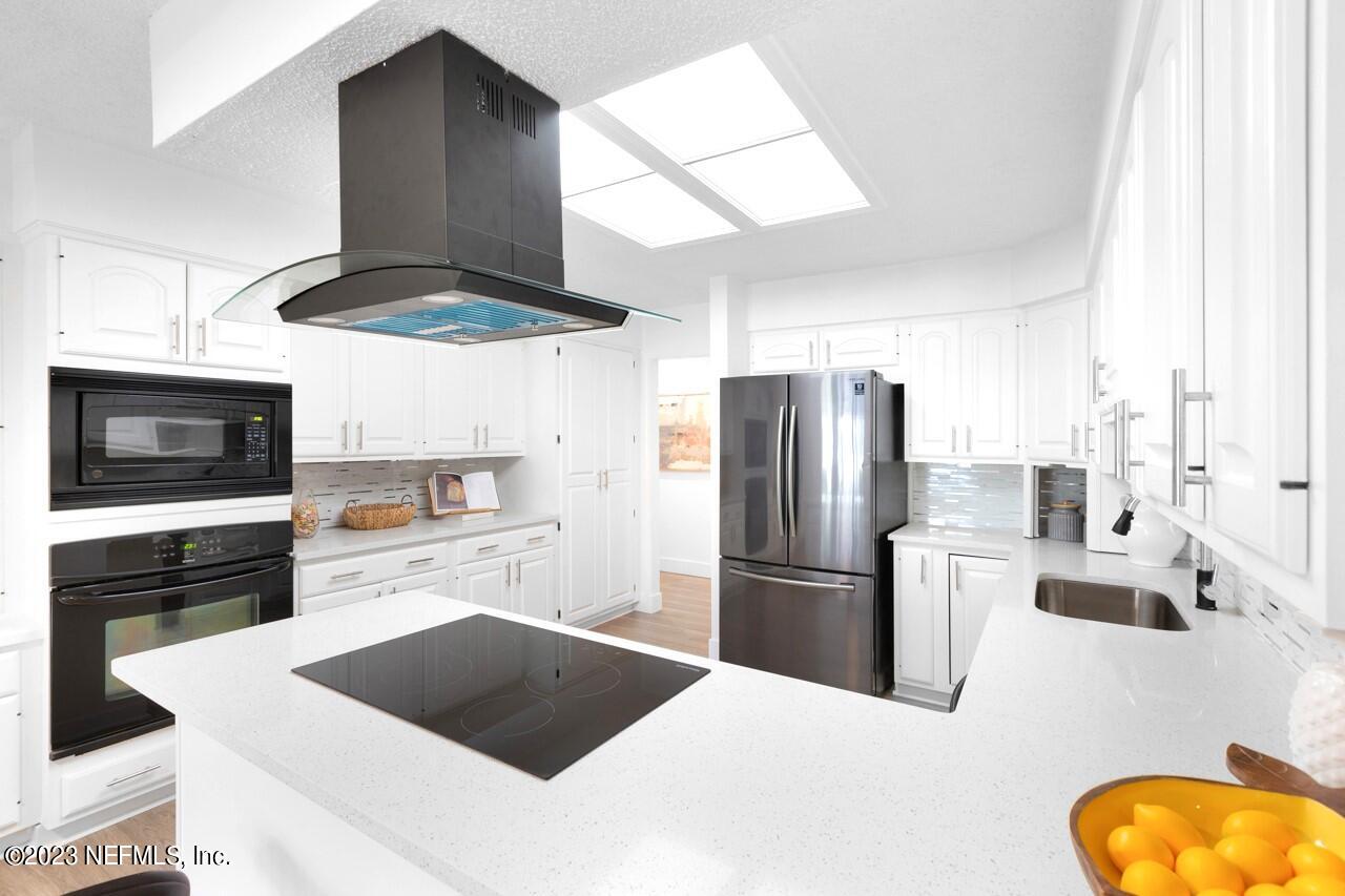 4309 Monument Road Jacksonville, FL 32225 - Photo 23 of 65 a kitchen with stainless steel appliances a stove a refrigerator and a sink