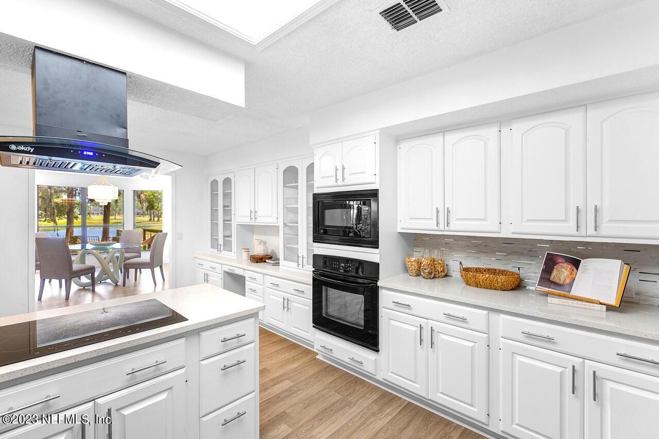 4309 Monument Road Jacksonville, FL 32225 - Photo 24 of 65 a kitchen with stainless steel appliances granite countertop a refrigerator and a stove top oven