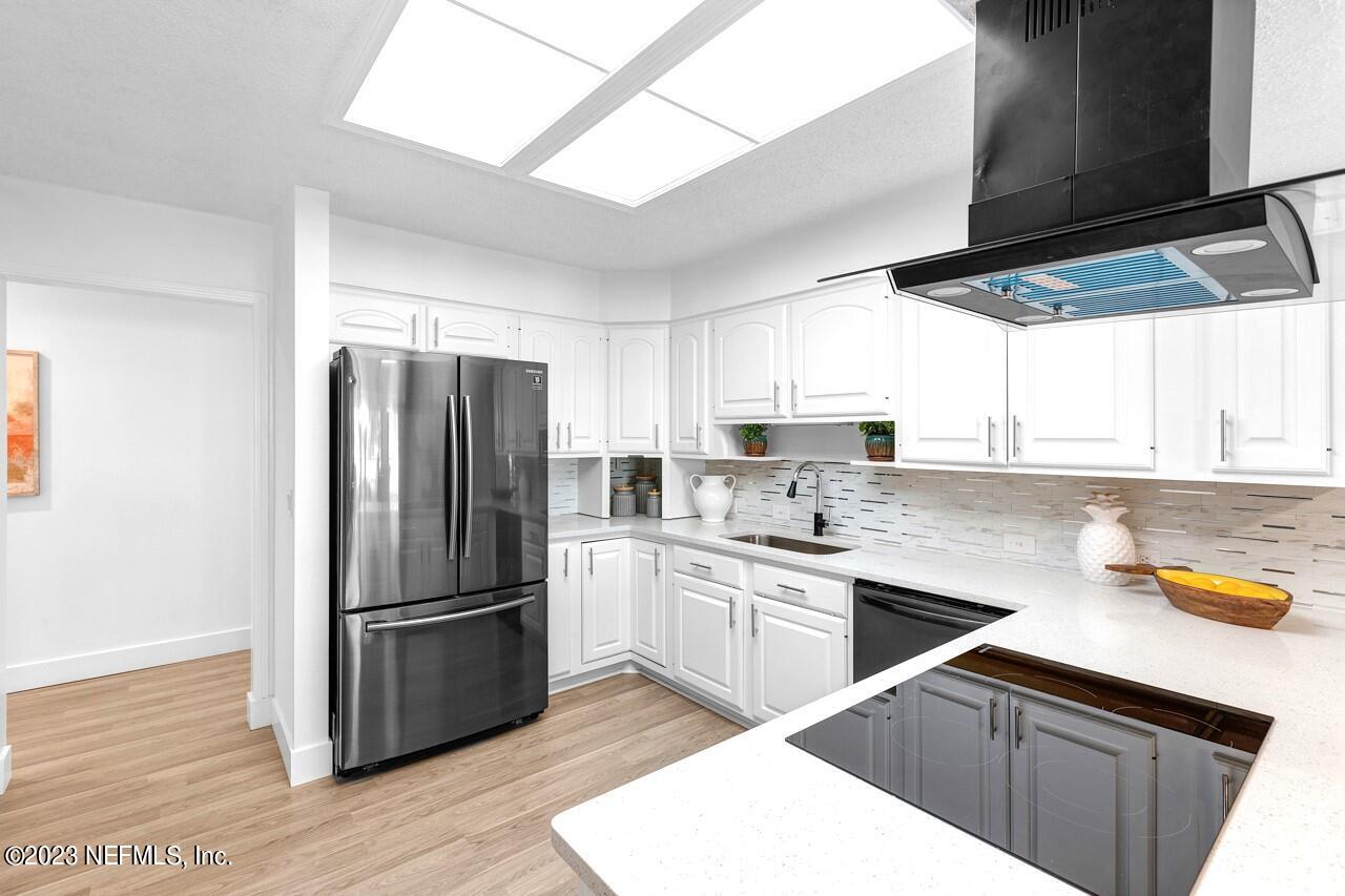 4309 Monument Road Jacksonville, FL 32225 - Photo 25 of 65 a kitchen with a sink a refrigerator and window